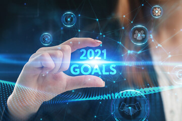 Fototapeta na wymiar Business, Technology, Internet and network concept. Young businessman working on a virtual screen of the future and sees the inscription: 2021 goals