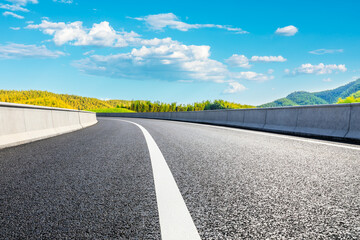 Asphalt road and green mountain with bamboo forest natural landscape.