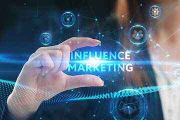 Business, Technology, Internet and network concept. Young businessman working on a virtual screen of the future and sees the inscription: Influence marketing