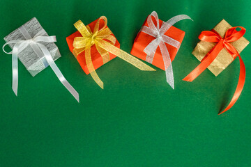 Festive banner with bright colorful gifts on a green background from above. Greeting card. Copy space. Top view.