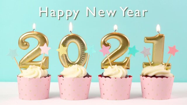 2021 Happy New Year's Eve pastel pink and blue theme cupcakes with large gold candles with animated text greeting.