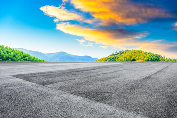 Asphalt road and green mountain with bamboo forest natural landscape at sunset.