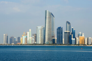 Fototapeta na wymiar Skyline of Abu Dhabi, United Arab Emirates with multiple skyscrapers in the Corniche. Multiple modern buildings with mirrored glass in the Middle East