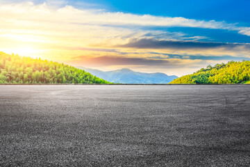 Asphalt road and green mountain with bamboo forest natural landscape at sunset.