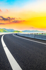 Country asphalt road and green tea plantation with bamboo forest natural landscape.