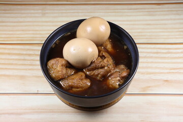 Hard boiled egg (Stewed egg) with fried tofu serving in sweet gravy soup. Famous Chinese traditional soup menu in ancient ceremony or festival. 
