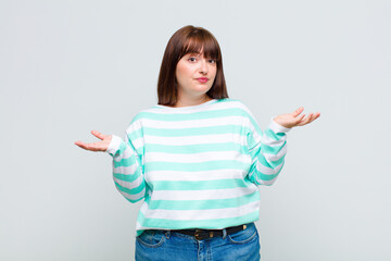 overweight woman feeling puzzled and confused, unsure about the correct answer or decision, trying...