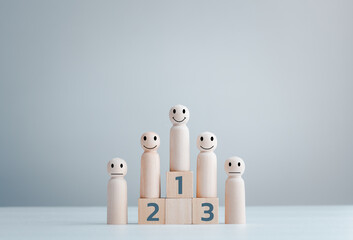 Business hierarchy; ranking and strategy concept with wood doll standing on a podium 1, 2, 3 of wooden building blocks with copy space.
