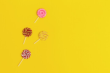 Colorful sweet candy lollypops on stick. Minimal still life composition with bright colors....
