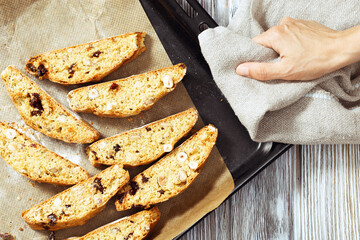 Italian biscotti cookies on black baking sheet. Fresh baked cookies with nuts