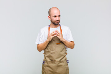 bald man scheming and conspiring, thinking devious tricks and cheats, cunning and betraying