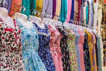 Middle East, Arabian Peninsula, Oman, Muscat, Muttrah. Dresses for sale at the Muttrah souk.
