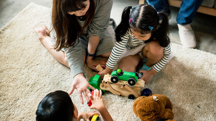 Japanese family playing with toys on the floor