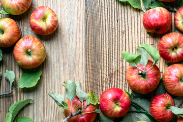 Red apple and leaf on wooden table