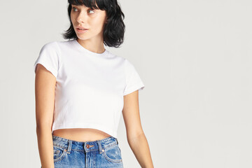 Woman in a white crop top and blue jeans - Powered by Adobe