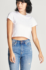 Women&#39;s sexy white crop top with high waisted jeans