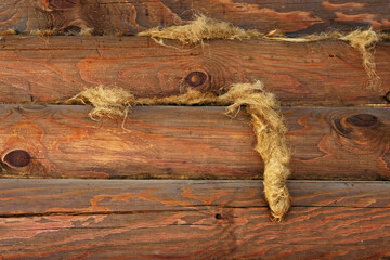 Fragment of a wooden log house with a fallen interventricular insulation