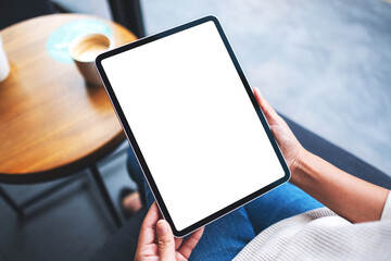 Mockup image of a woman holding digital tablet with blank white desktop screen