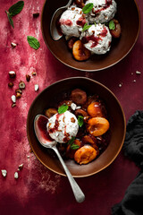 Ice cream roasted plums top view with chopped hazelnut