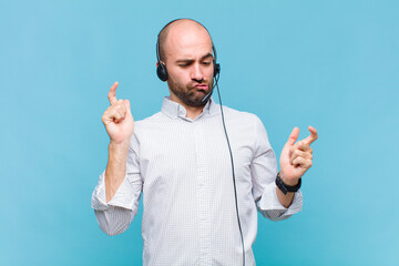 bald man shrugging with a dumb, crazy, confused, puzzled expression, feeling annoyed and clueless