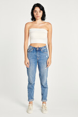 Woman in high-waisted jeans and a white bandeau top mockup