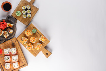 Appetizing rolls on a white background. Japanese food concept. Close-up. Copy space. Flat lay.