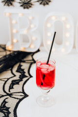 Halloween party decoration with a red drink in a glass