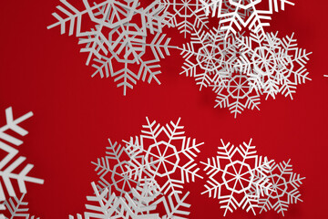 Fototapeta na wymiar 3d illustration of many snowflakes of different sizes and shapes on a red background. Winter snowflake pattern