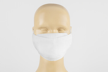 White fabric face mask on a mannequin