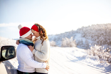 Couple in relationship  standing  outdoors in snowy winter. Happy people hugging outdoors in ice landscape. Symbol shaped valentines day, lifestyle and feeling concept