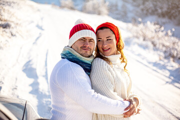 Couple in relationship  standing  outdoors in snowy winter. Happy people hugging outdoors in ice landscape. Symbol shaped valentines day, lifestyle and feeling concept