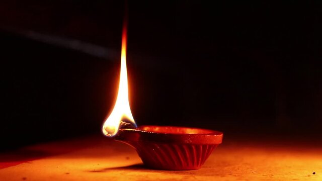 Clay Diya or Oil Lamps lit during the Diwali night. Close up of illuminating diya, clay lamp during celebration of Indian festival Diwali