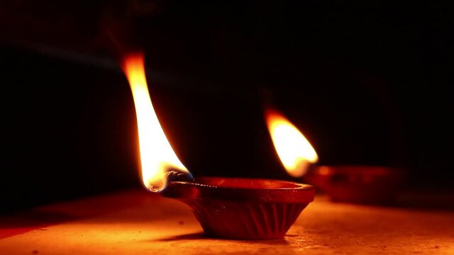 Clay Diya or Oil Lamps lit during the Diwali night. Close up of illuminating diya, clay lamp during celebration of Indian festival Diwali