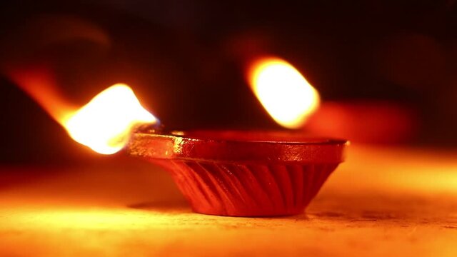 Clay Diya or Oil Lamps lit during the Diwali night. Close up of illuminating diya, clay lamp during celebration of Indian festival Diwali