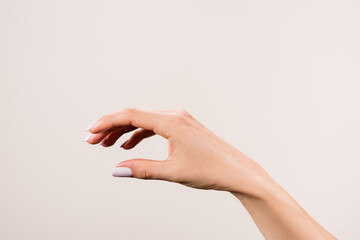 cropped view of female hand isolated on grey, stock image