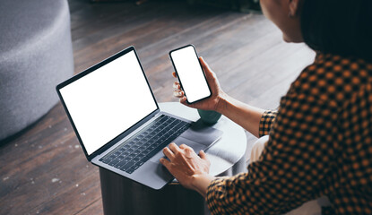 computer,cell phone blank screen mockup.hand woman work using laptop texting mobile. with white background for advertising,contact business search information on desk in cafe.marketing,design