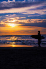 surf boy in sand water beach waves sunset ecuador montañita latin america
