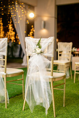 gold chiavari chair decorate with a rose on a wedding day