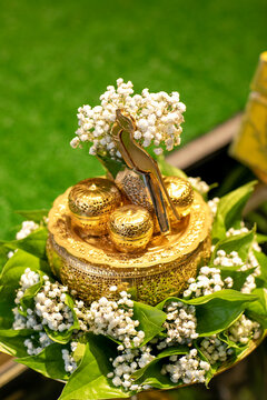 A beautiful gold tepak sireh for wedding dowry decorate with betel leaves and baby breath flower