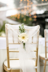 gold chiavari chair decorate with a flower on a wedding day