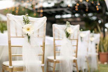 gold chiavari chair decorate with a flower on a wedding day