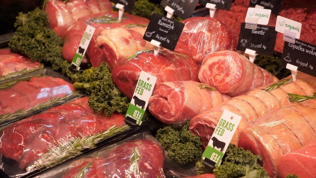 Animal protein sources in food. Freshly cut red meat stall in grocery shop 