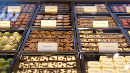 Display of exclusive chocolate artisan candies in wide assortment. Confectionery shop concept