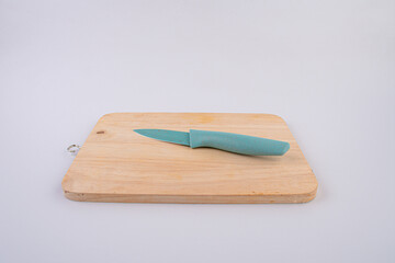 Wooden cutting board and knife isolated on white background. 