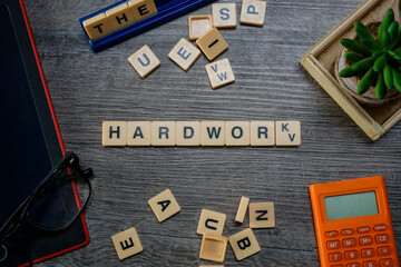 Alphabets spelled HARD WORK flat lays on wooden background layouts.