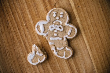 Broken Christmas Gingerbread Man Cookie On Wooden Board