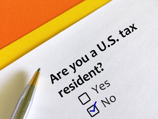 One person is answering question. The person is thinking if he is United states tax resident. He is...