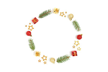 Wreath made of colorful Christmas decorations and spruce branches. Minimalist festive frame on a white background.