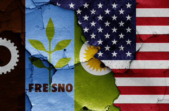 flags of Fresno and USA painted on cracked wall
