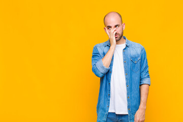 bald man feeling bored, frustrated and sleepy after a tiresome, dull and tedious task, holding face...